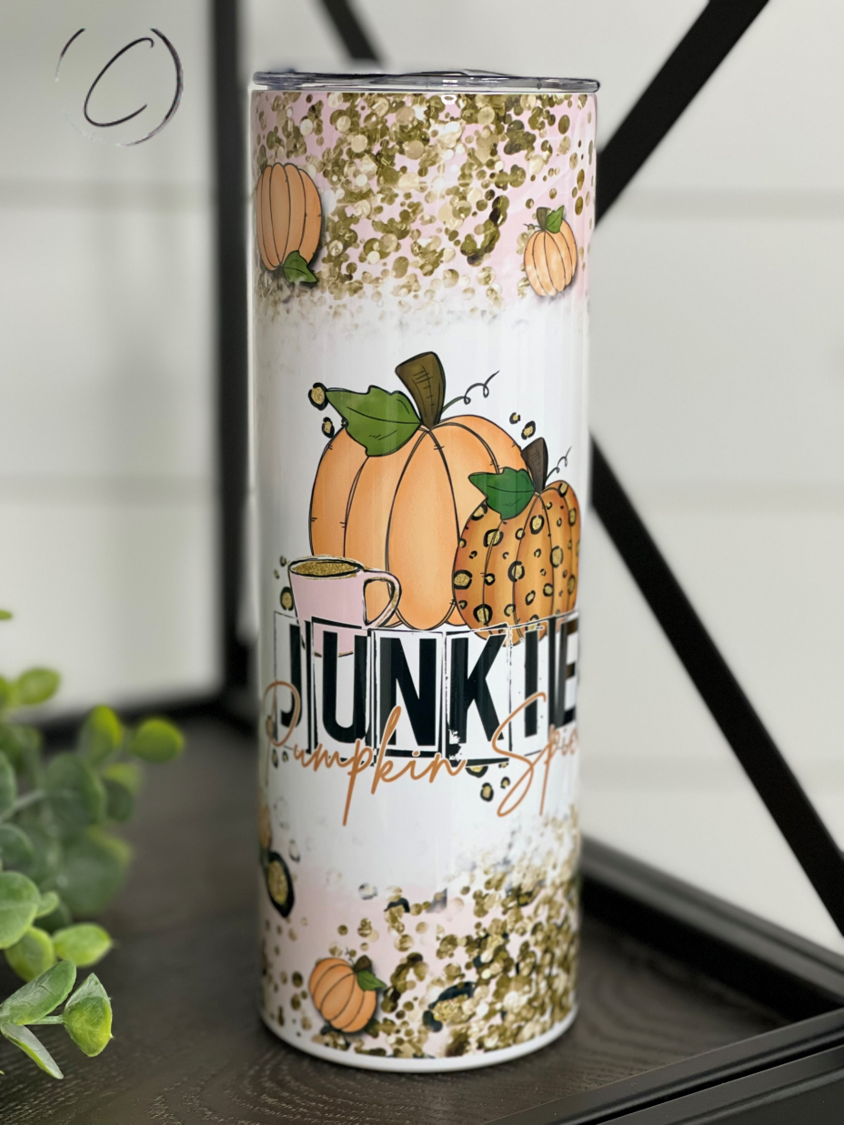 Pumpkin Spice Junkie 20oz Skinny Tumbler featuring a vibrant pumpkin spice design, complete with a reusable straw.