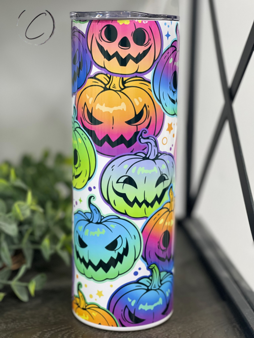 A colorful 20oz skinny tumbler featuring a vibrant rainbow jack-o'-lantern design, perfect for Halloween drinks.