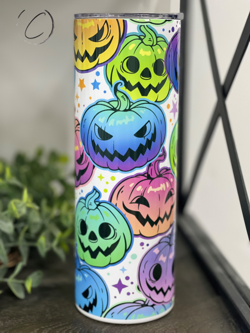 A colorful 20oz skinny tumbler featuring a vibrant rainbow jack-o'-lantern design, perfect for Halloween drinks.