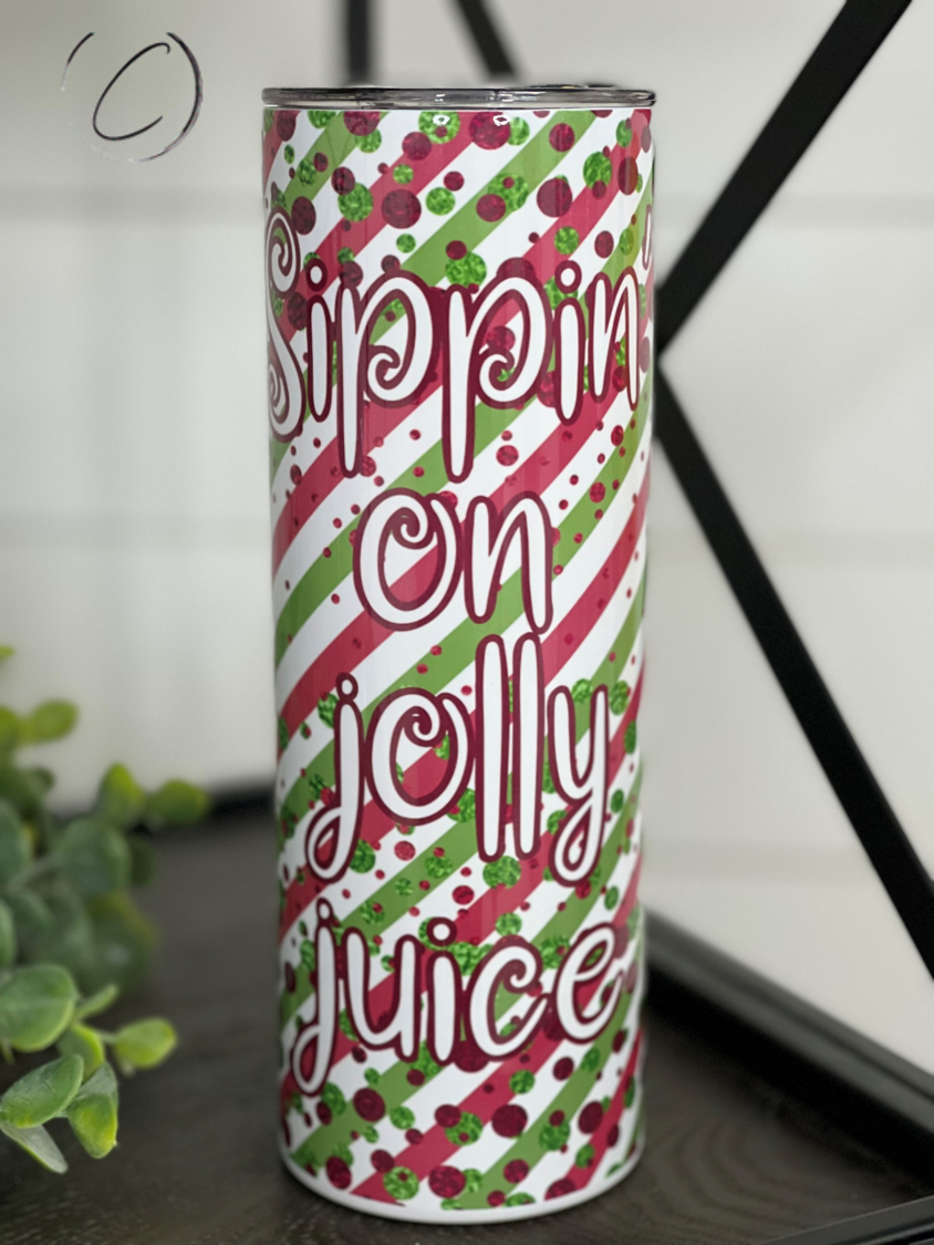 Sippin' On Jolly Juice 20oz Skinny Tumbler with vibrant full wrap design and reusable straw.