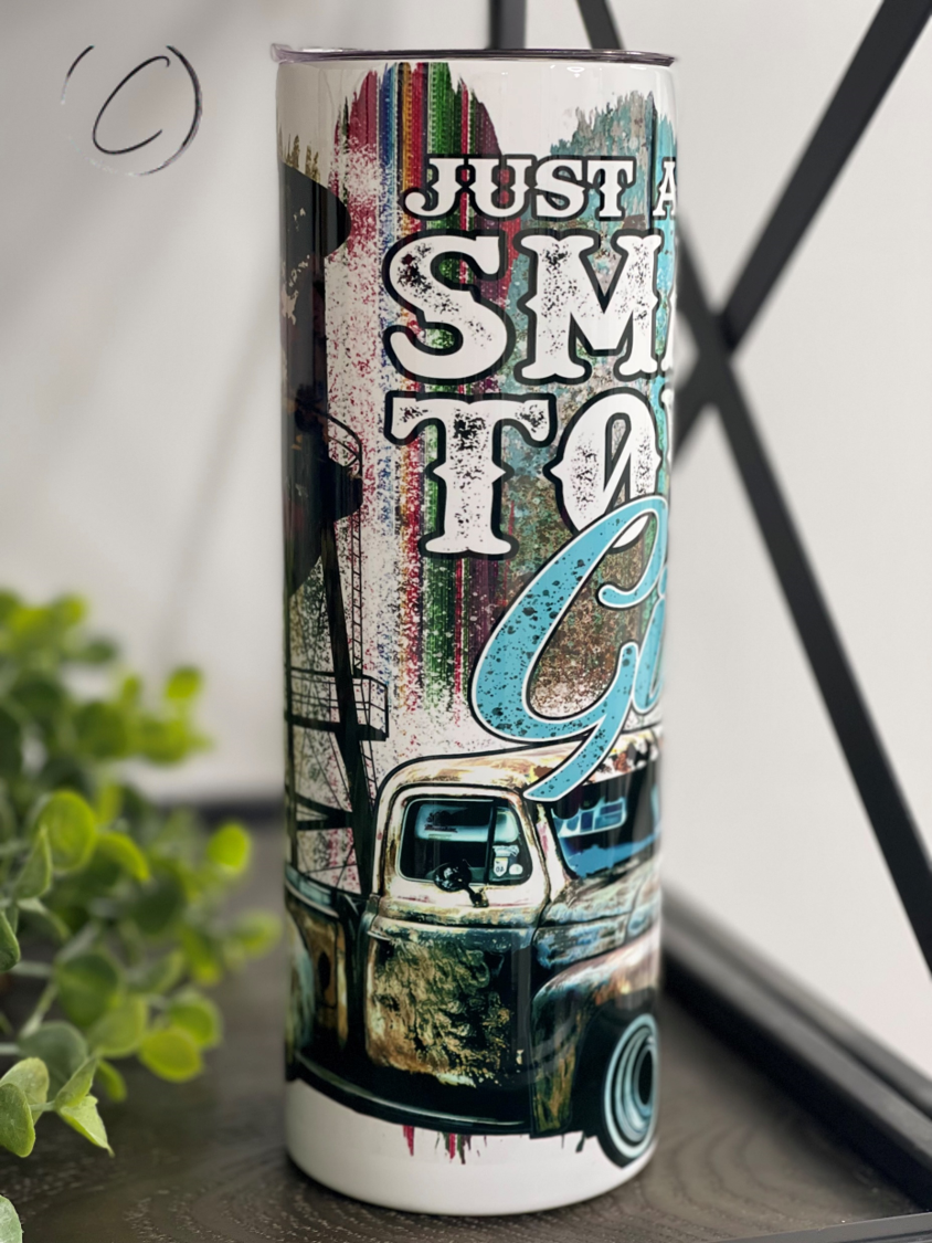 Small Town Girl Water Tower 20oz Skinny Tumbler with a charming water tower design, featuring a reusable straw.