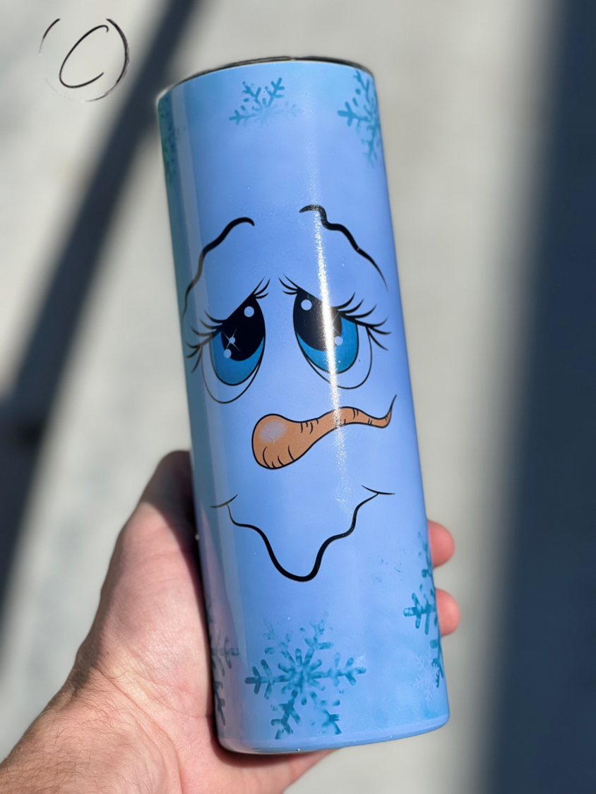 Snowflake Snowman 20oz UV Blue Skinny Tumbler with color-changing effect in sunlight, featuring a whimsical snowman design.