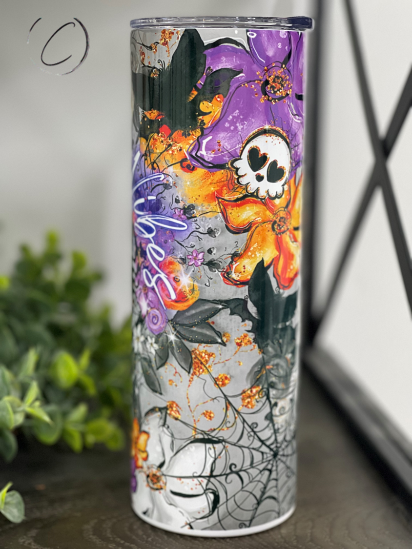 Spooky Vibes 20oz Skinny Tumbler featuring a full wrap Halloween design with a reusable straw.