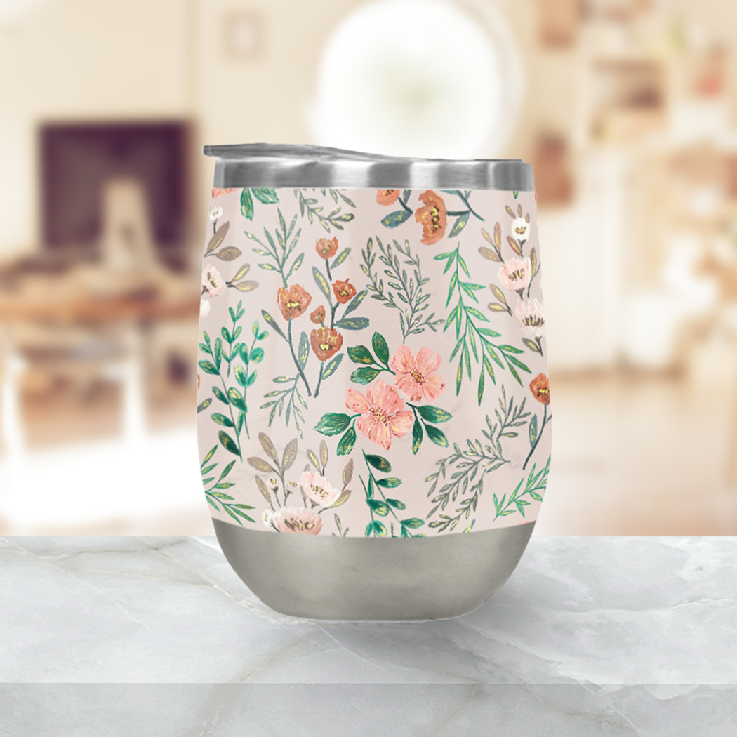 A vibrant Springtime Wine Tumbler made of stainless steel, showcasing its double-wall vacuum insulation and included plastic lid, perfect for outdoor use.