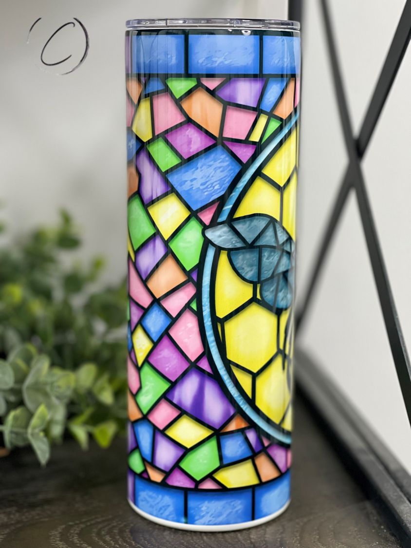 A stylish 20oz skinny tumbler featuring a vibrant stained glass bee design, perfect for drinks on the go.