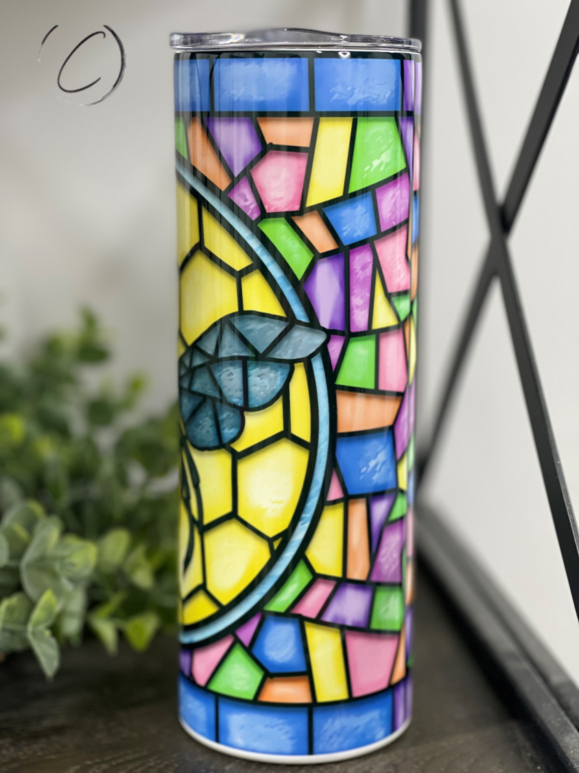 A stylish 20oz skinny tumbler featuring a vibrant stained glass bee design, perfect for drinks on the go.