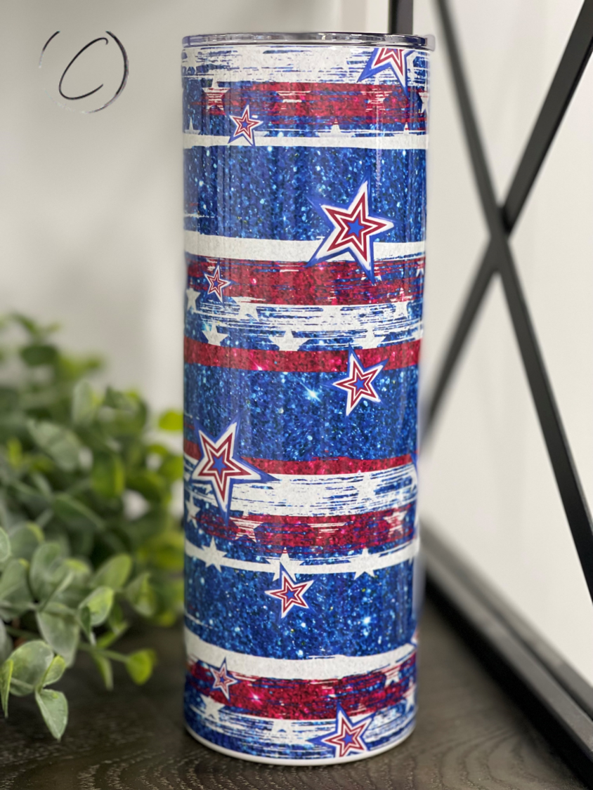 Stars & Stripes 20oz Skinny Tumbler featuring a vibrant patriotic design with a reusable straw.