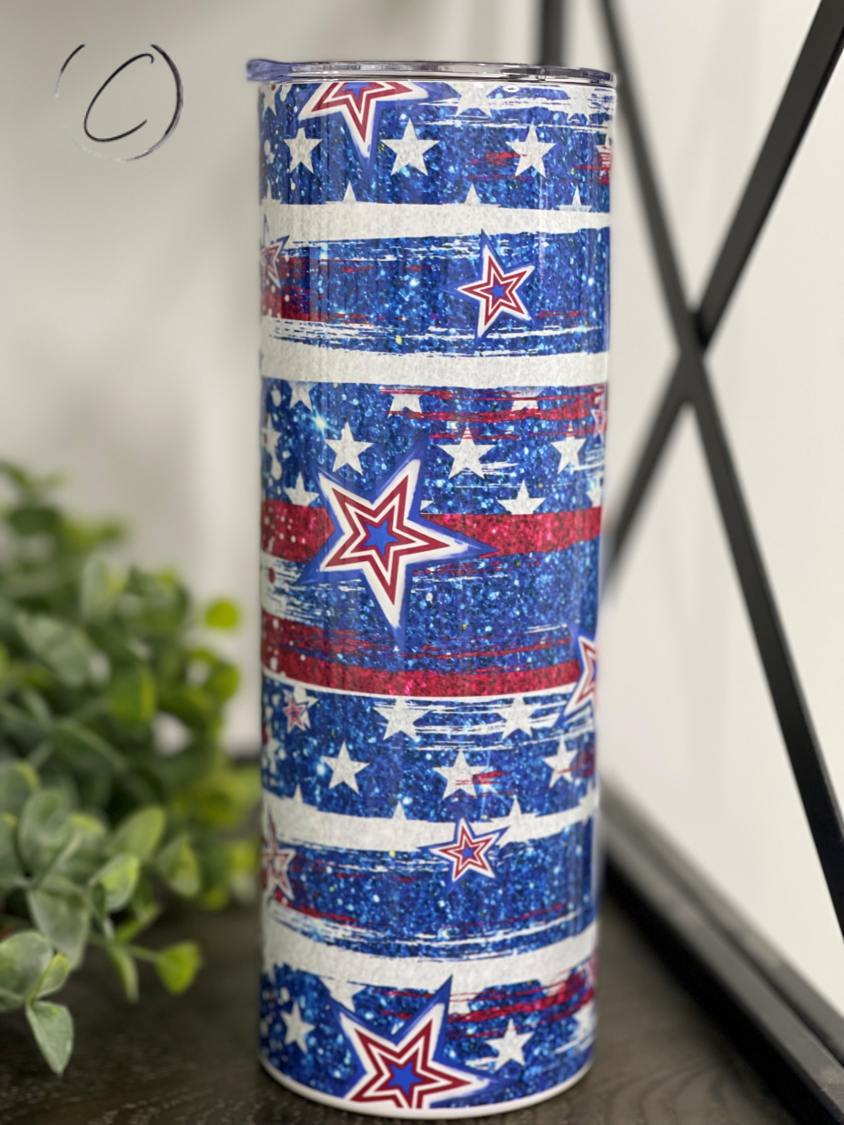 Stars & Stripes 20oz Skinny Tumbler featuring a vibrant patriotic design with a reusable straw.