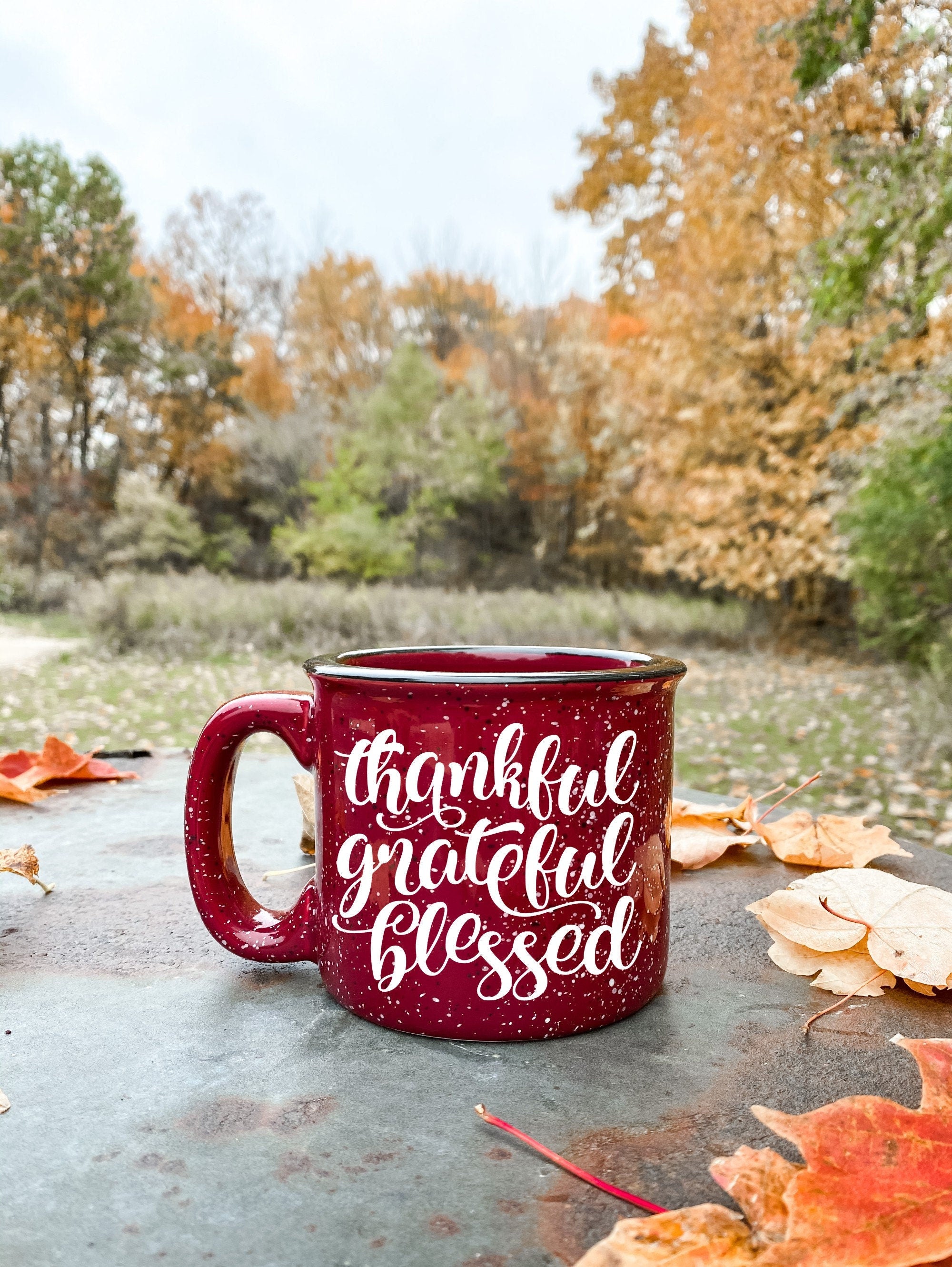 A ceramic coffee mug featuring the phrase 'Thankful Grateful and Blessed' printed on one side, showcasing a stylish design.