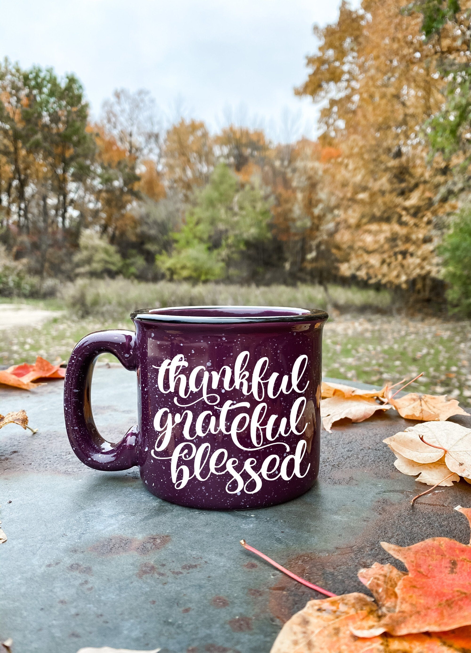 A ceramic coffee mug featuring the phrase 'Thankful Grateful and Blessed' printed on one side, showcasing a stylish design.