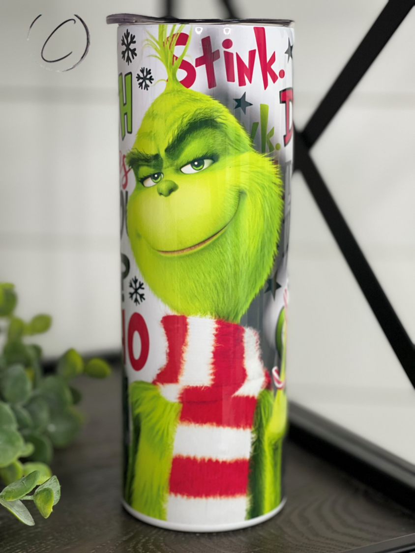 The Grinch 20oz Skinny Tumbler featuring a vibrant design, reusable straw, and durable construction.