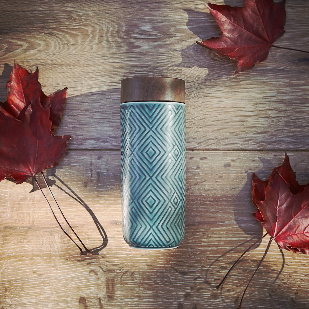 The Miracle Ceramic Tumbler showcasing its elegant design with a bamboo effect lid, featuring a tourmaline lining for enhanced beverage purity.