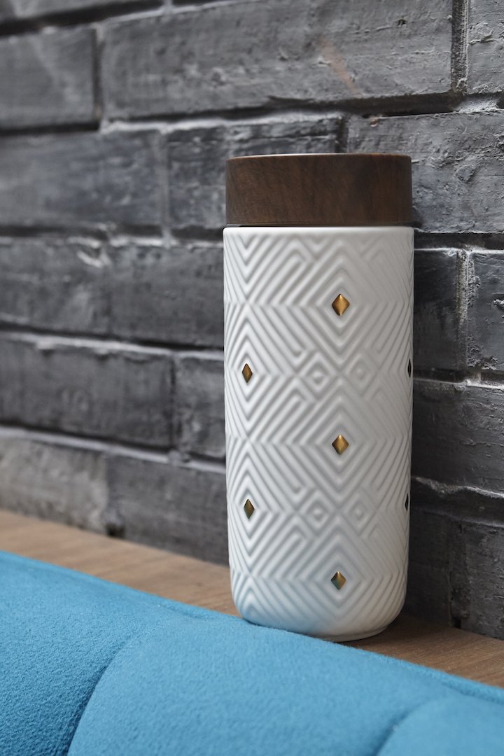 The Miracle Gold Ceramic Tumbler featuring a gold ceramic finish, walnut wood effect lid, and double wall insulation for optimal temperature retention.