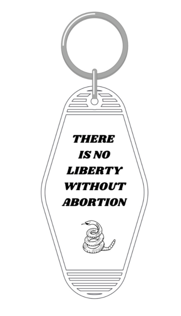 Black and white keychain with the phrase 'There is no liberty without abortion' on a split ring, styled like a classic motel key tag.