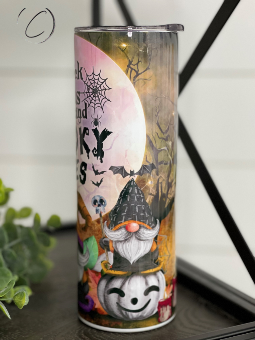 A stylish 20oz skinny tumbler featuring a vibrant design with the phrase 'Thick Thighs & Spooky Vibes', perfect for Halloween and everyday use.