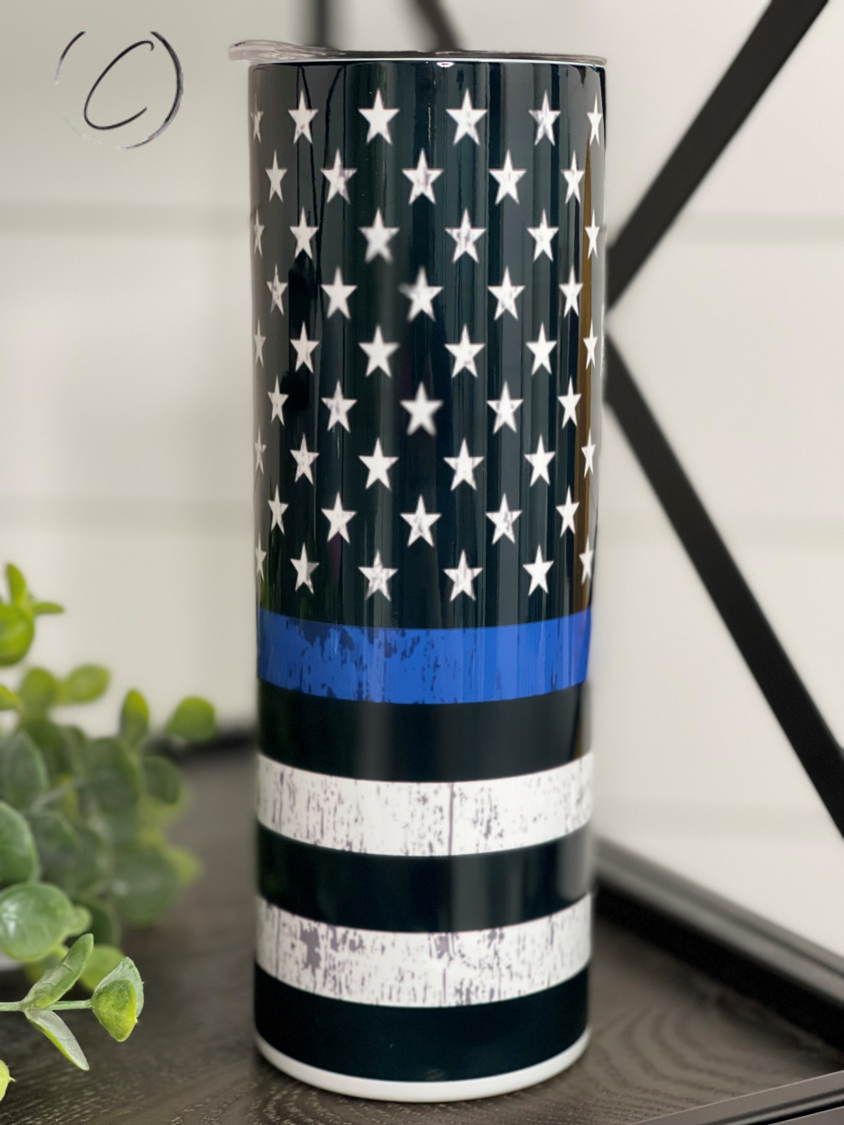 Thin Blue Line 20oz Skinny Tumbler showcasing a full wrap design with a reusable straw, perfect for hot and cold beverages.