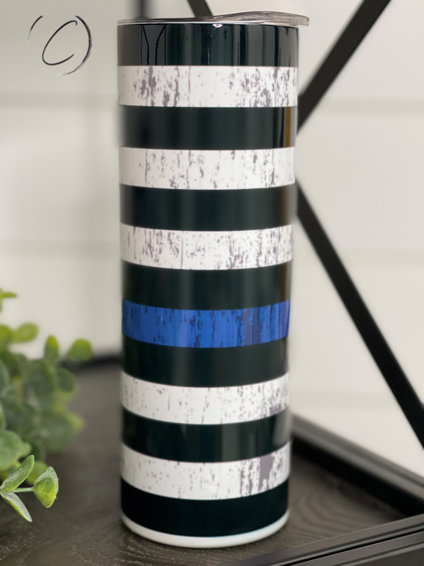 Thin Blue Line 20oz Skinny Tumbler showcasing a full wrap design with a reusable straw, perfect for hot and cold beverages.