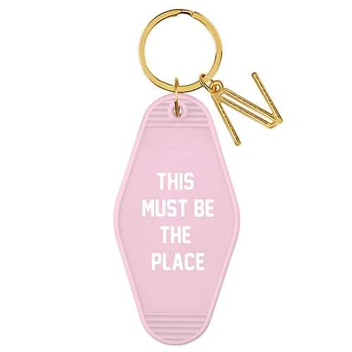 This Must Be The Place Pink Motel Key Tag featuring white lettering and a gold ring, designed in a vintage style.