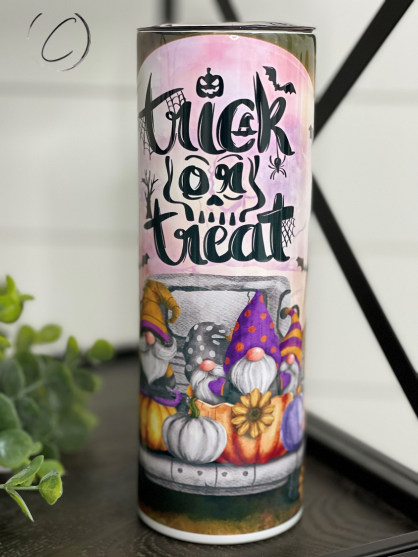 Trick Or Treat Gnomes 20oz Skinny Tumbler featuring vibrant gnome design, reusable straw, and durable construction.