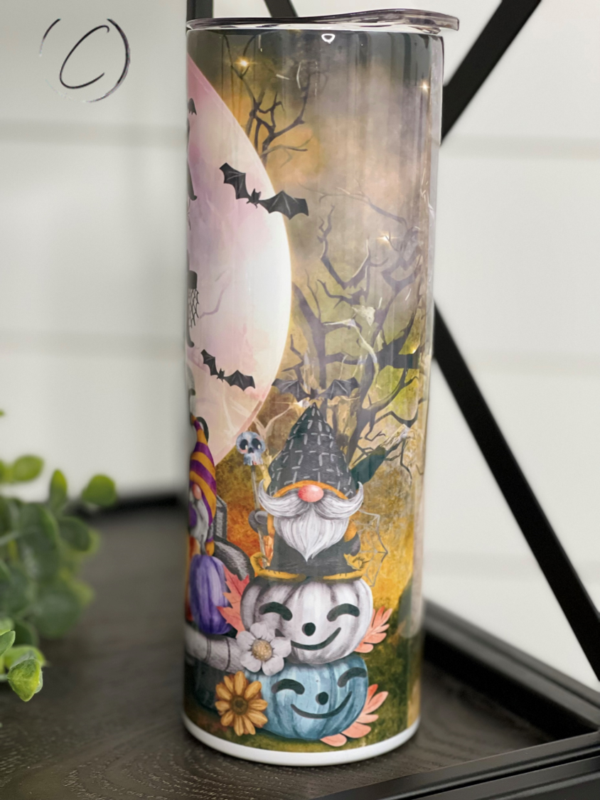 Trick Or Treat Gnomes 20oz Skinny Tumbler featuring vibrant gnome design, reusable straw, and durable construction.