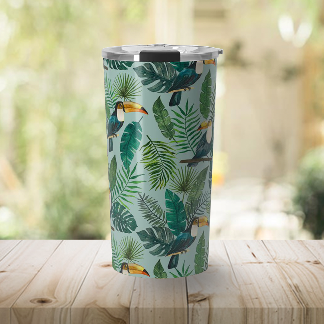 A vibrant Tropical Toucan Travel Mug made of stainless steel, featuring a colorful toucan design and a vacuum-sealed lid.