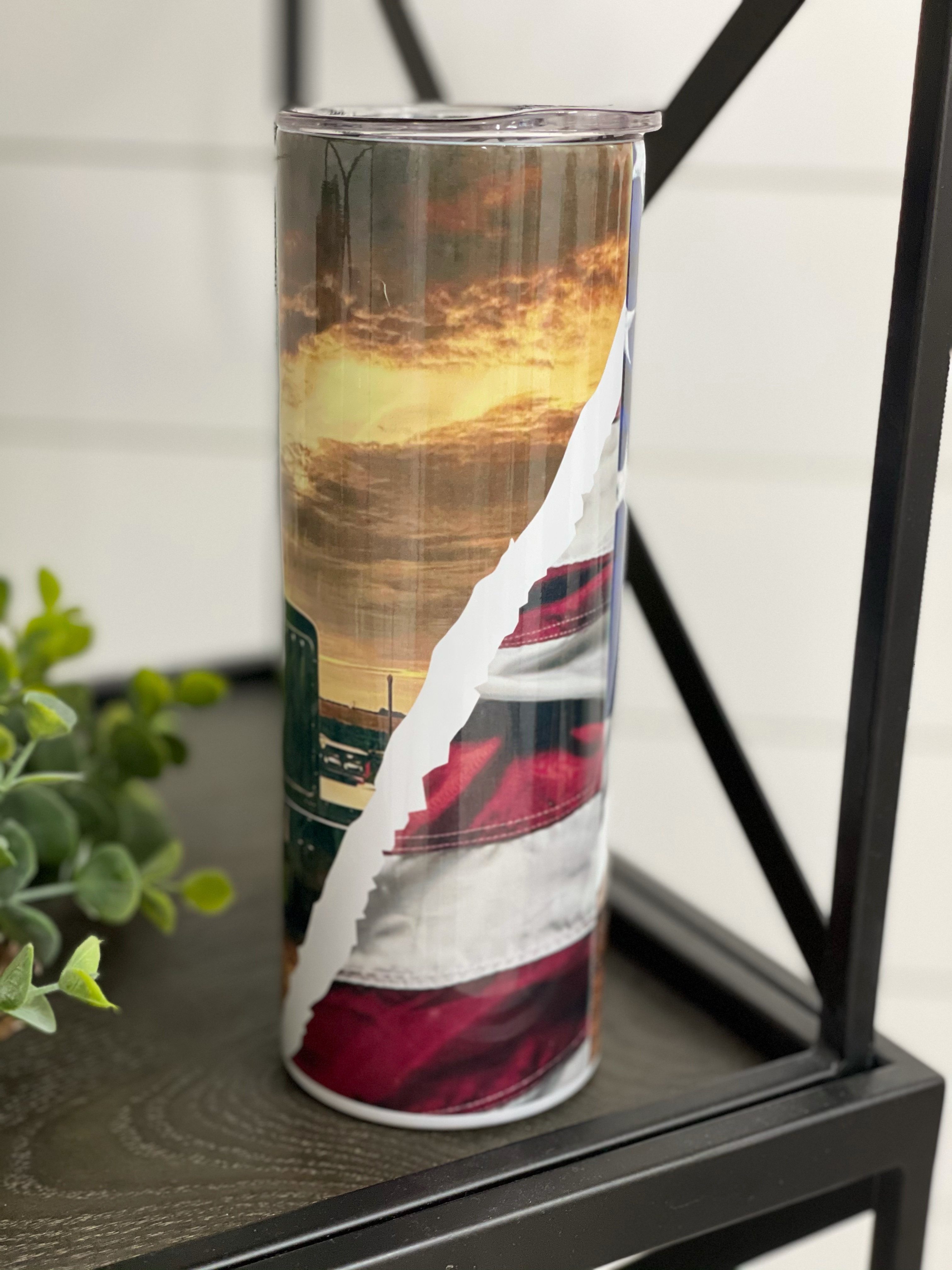 Trucker 20oz Skinny Tumbler with vibrant full wrap design and reusable straw, showcasing its high-quality construction.