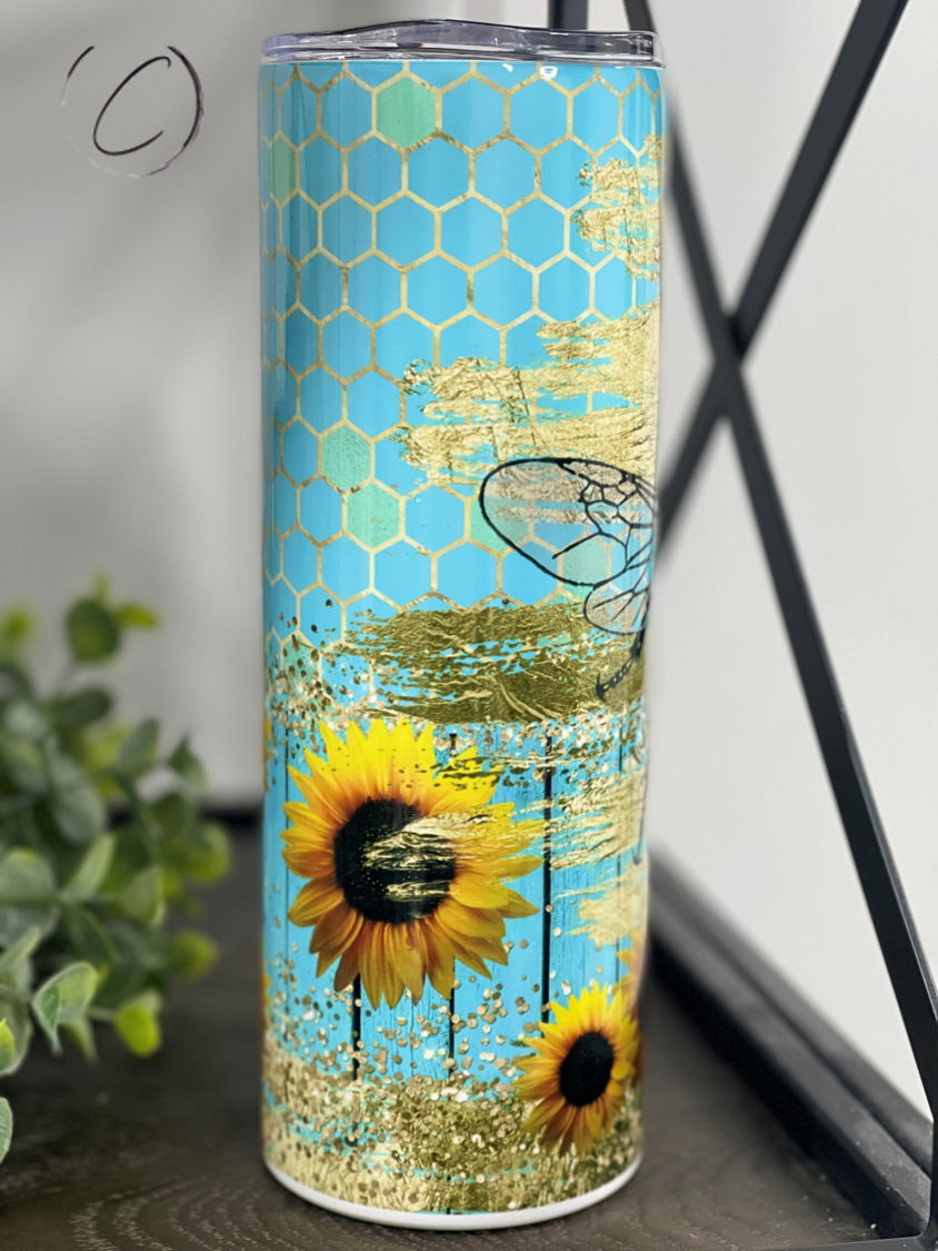 Turquoise Queen Bee 20oz Skinny Tumbler with a vibrant design and reusable straw, perfect for stylish hydration.