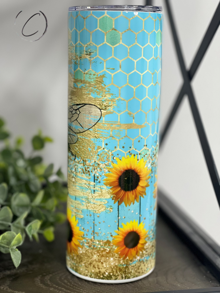 Turquoise Queen Bee 20oz Skinny Tumbler with a vibrant design and reusable straw, perfect for stylish hydration.