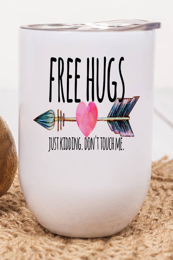 A 12 oz stainless steel wine tumbler with a humorous design that reads 'Free Hugs Just Kidding', featuring a lid and plastic straw.