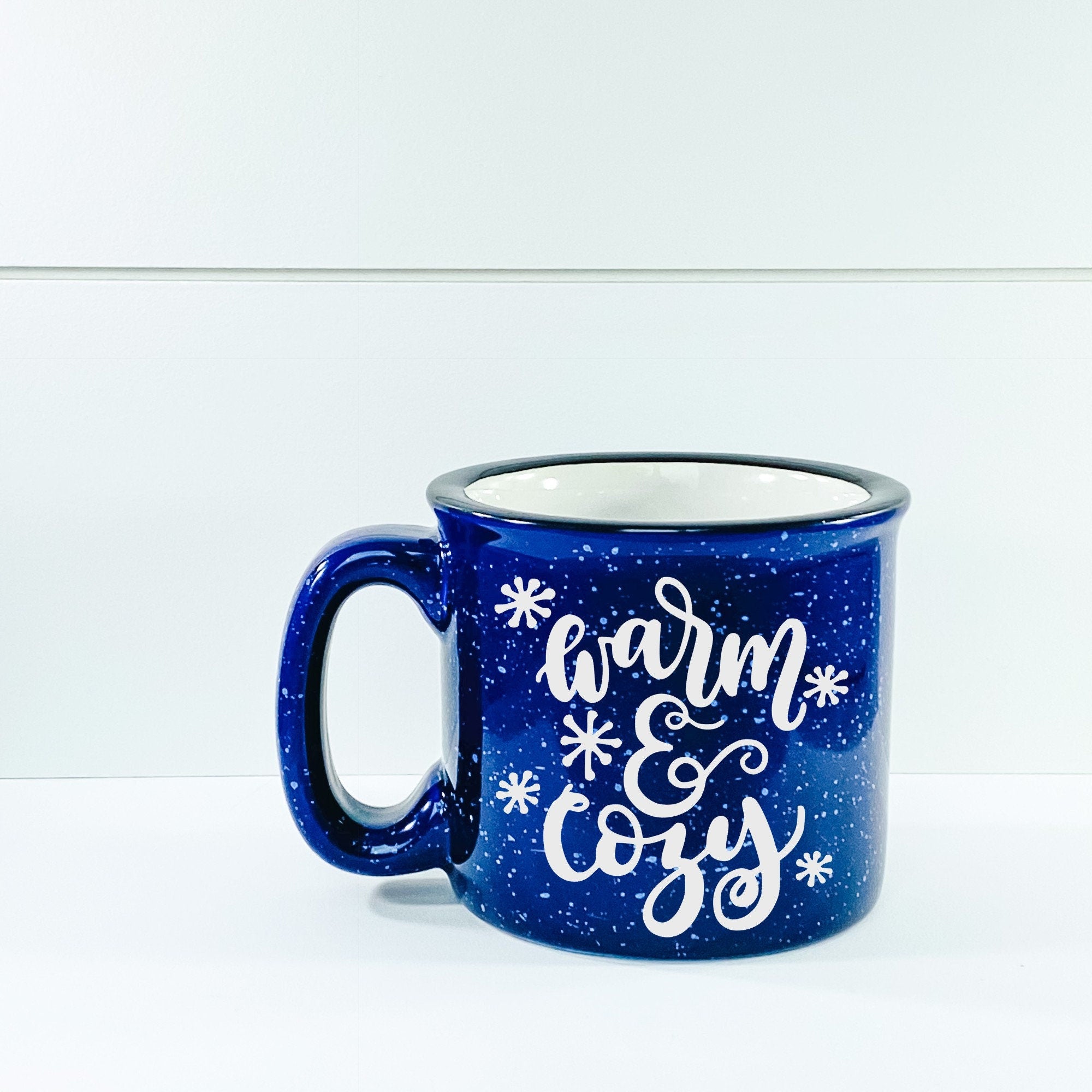 Warm And Cozy Campfire Mug in ceramic with a charming design, perfect for outdoor and indoor use.