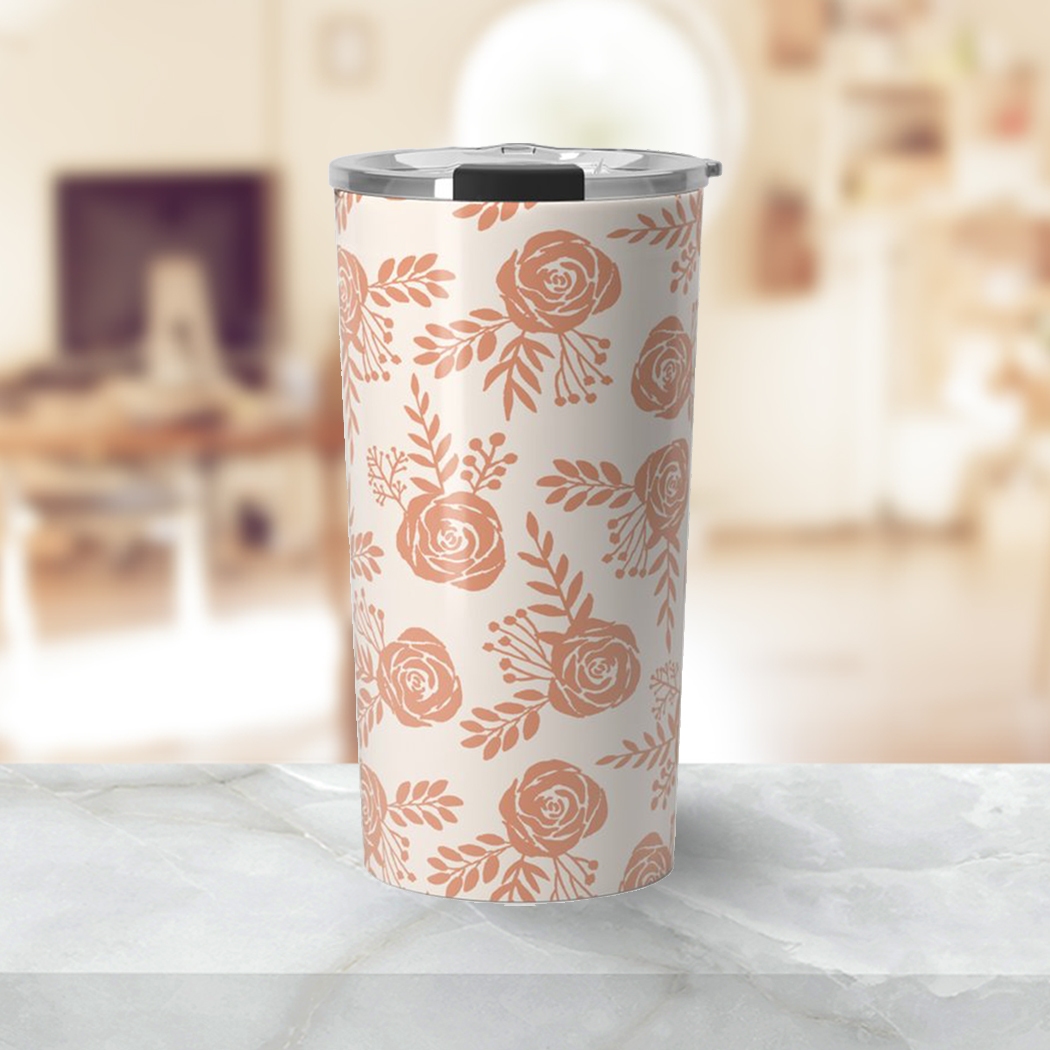 Warm orange floral travel coffee mug made of stainless steel with a double-wall design, featuring a vibrant floral pattern.