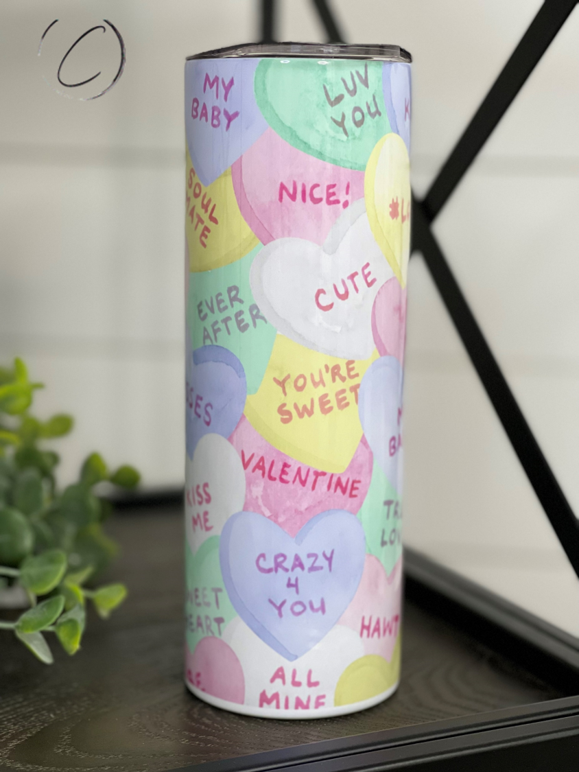 A colorful 20oz skinny tumbler featuring a water color heart design, perfect for drinks on the go.