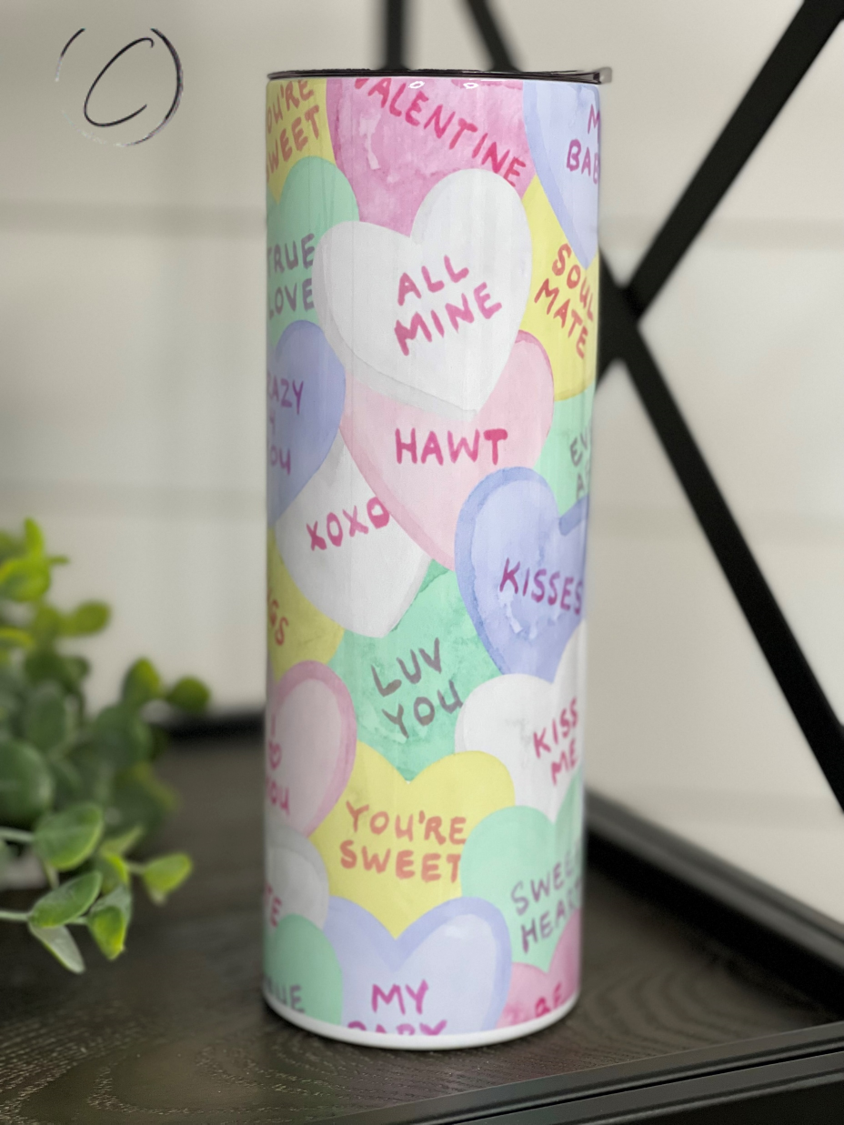 A colorful 20oz skinny tumbler featuring a water color heart design, perfect for drinks on the go.