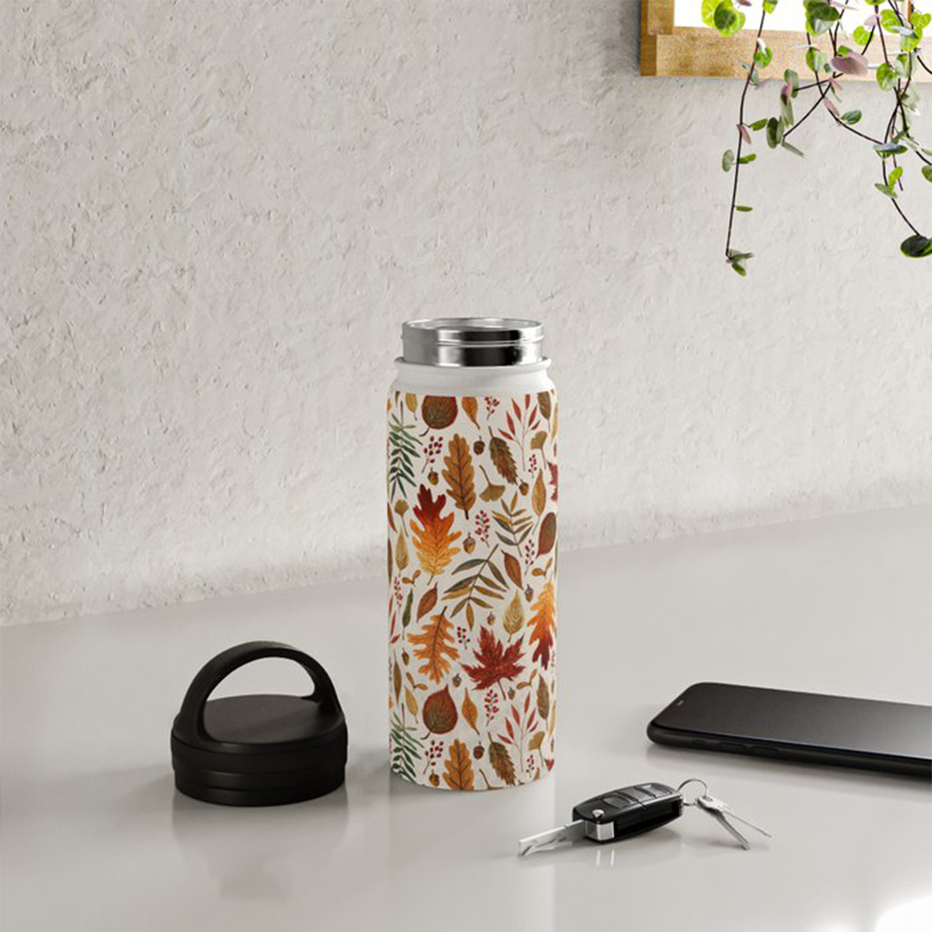 A stylish stainless steel water bottle featuring a watercolor fall leaves design and a convenient handle lid, perfect for hydration on-the-go.