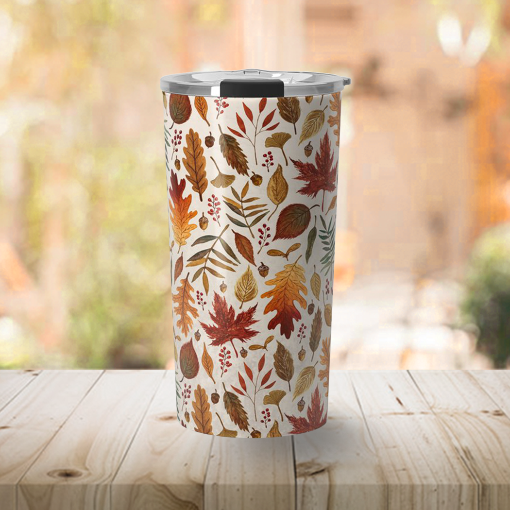 A stylish 20oz travel mug featuring watercolor fall leaves design, made of stainless steel with a vacuum-sealed lid.