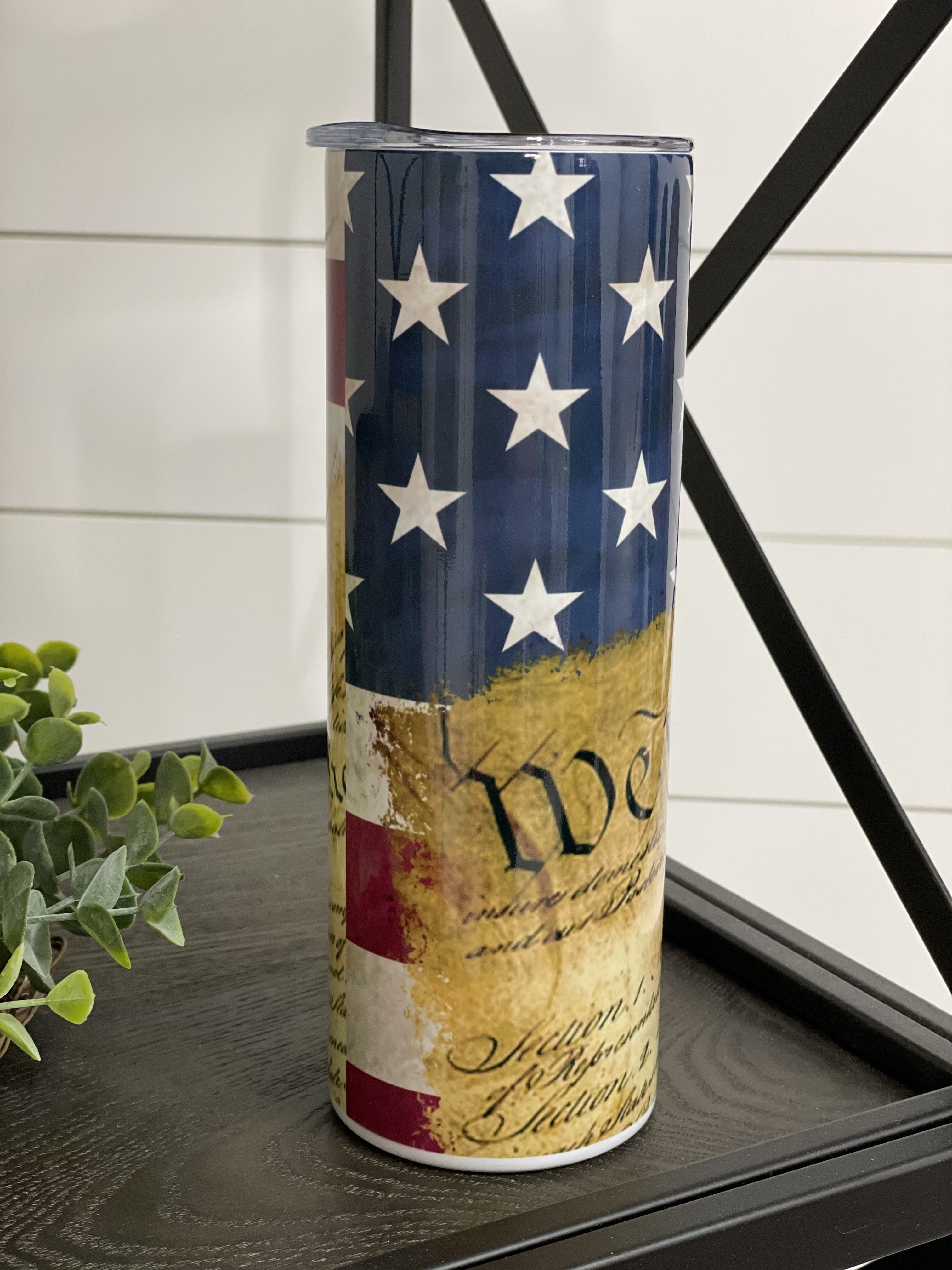 We The People 20oz Skinny Tumbler with a full wrap design, featuring a reusable straw and high-quality finish.