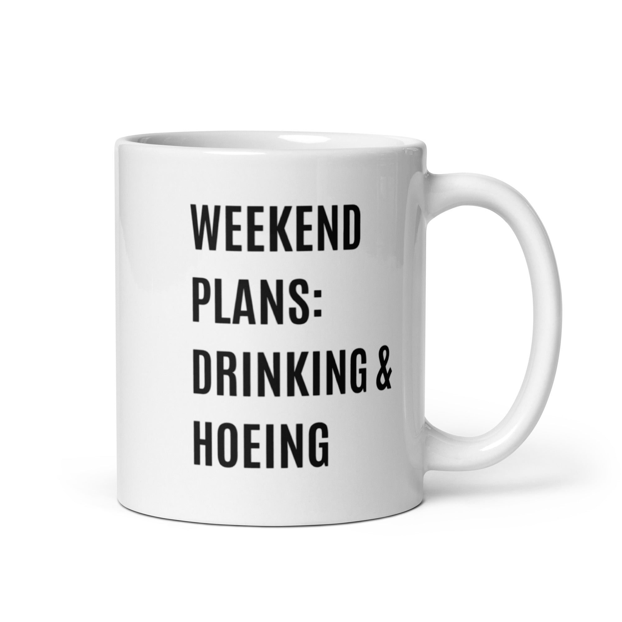 Ceramic mug with a humorous design featuring 'Weekend Plans Drinking & Hoeing', available in two sizes.