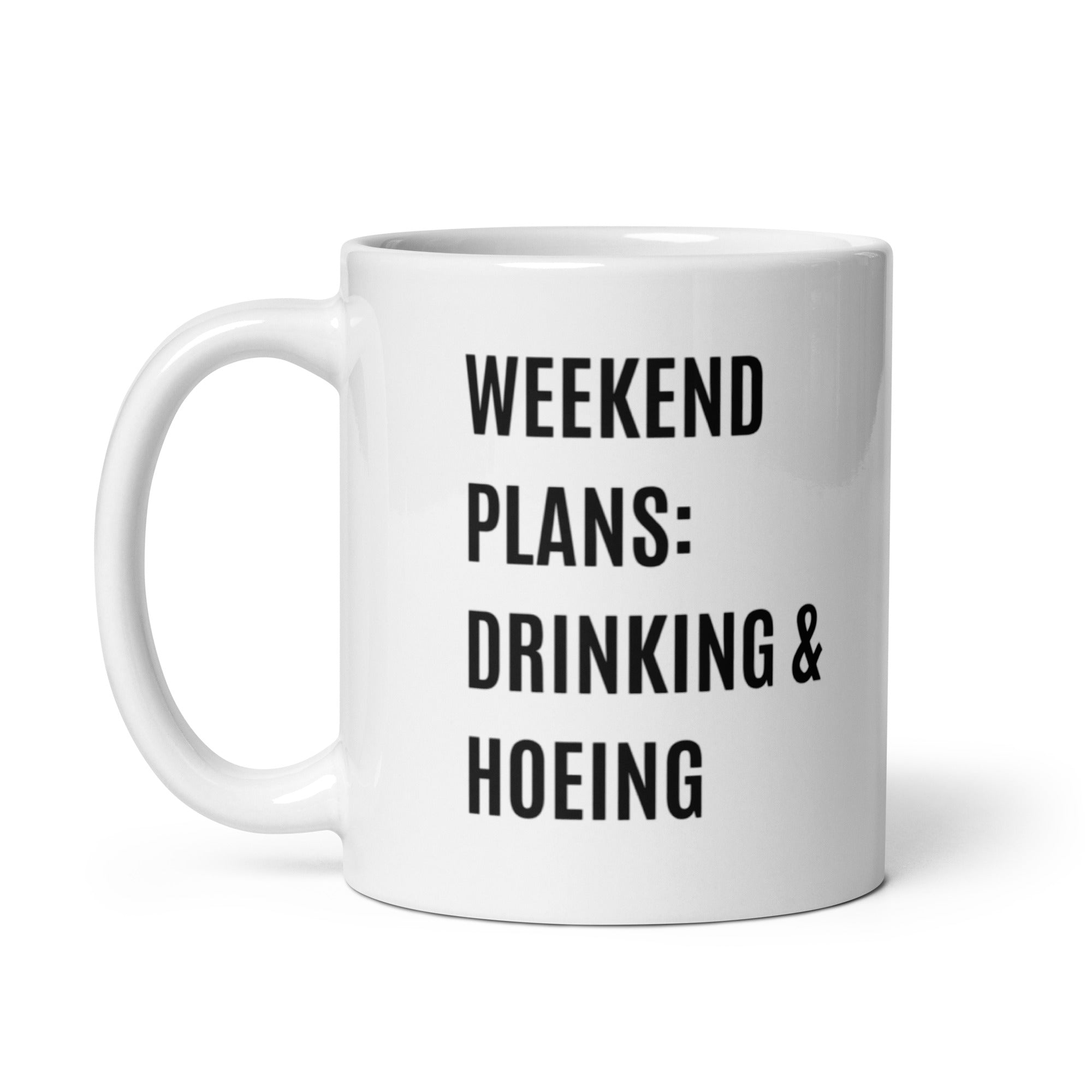 Ceramic mug with a humorous design featuring 'Weekend Plans Drinking & Hoeing', available in two sizes.