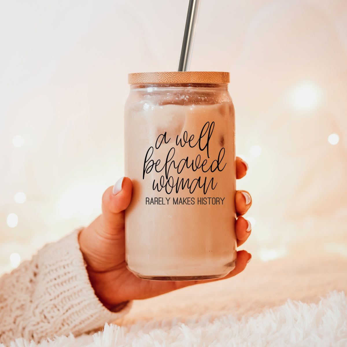 Well Behaved Woman Glass Cup with bamboo lid and stainless steel straws, showcasing a stylish black graphic design.