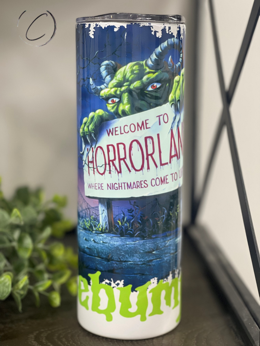 Welcome To Horrorland 20oz Skinny Tumbler featuring a vibrant horror-themed design, perfect for drinks.