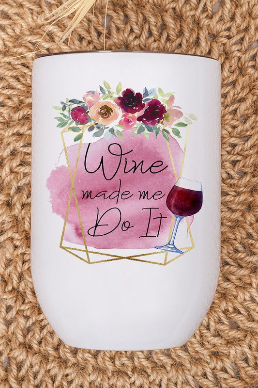 A 12 oz stainless steel wine tumbler with a fun 'Wine Made Me Do It' graphic printed on both sides, featuring a lid and plastic straw.