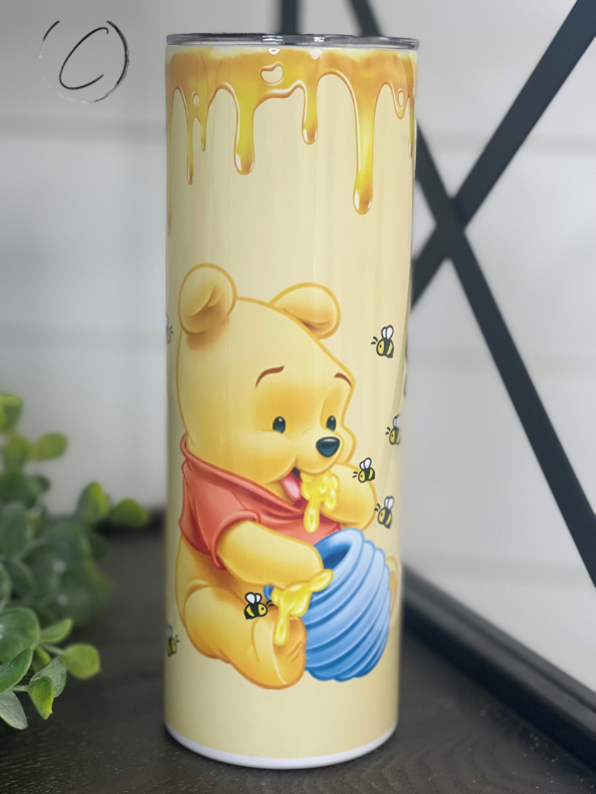 Winnie The Pooh 20oz Skinny Tumbler featuring a vibrant design, perfect for hydration on the go.