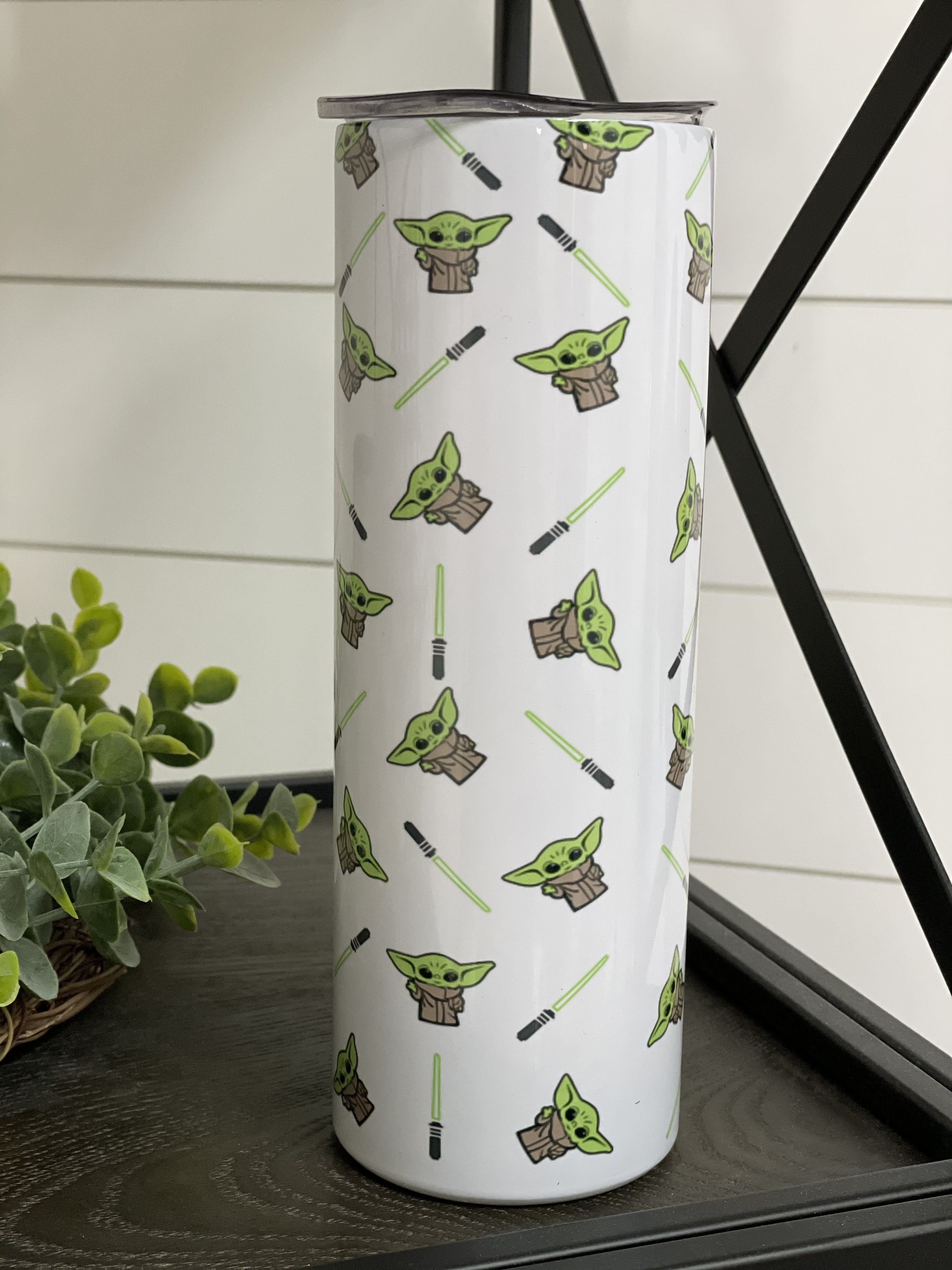 Yoda Saber 20oz Skinny Tumbler featuring a vibrant design, reusable straw, and durable construction.