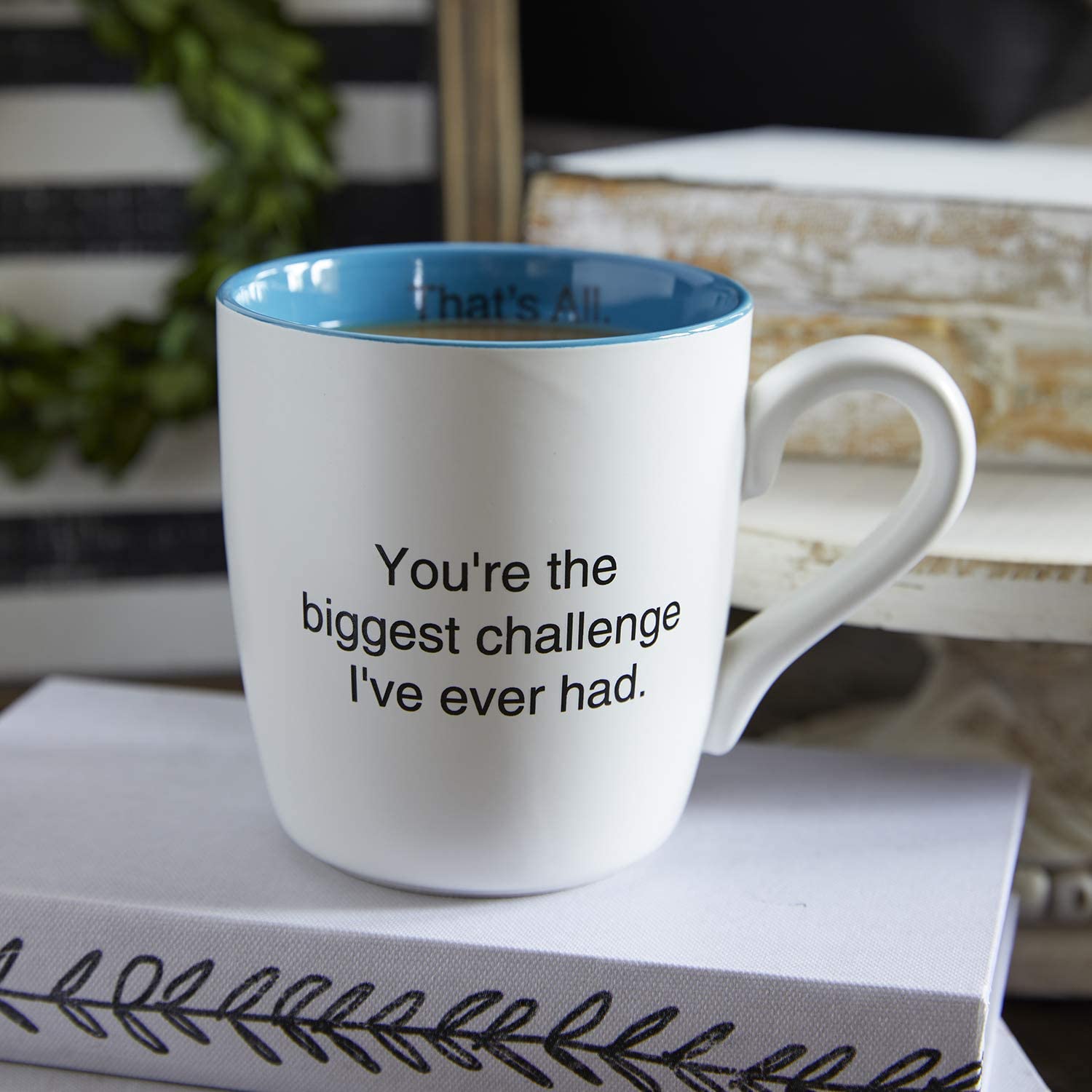 Teal ceramic coffee mug with a witty statement, featuring a matte white exterior and a teal inner dip.