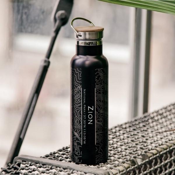 Custom engraved stainless steel bottle featuring a map of Zion National Park with a bamboo top in matte black finish.