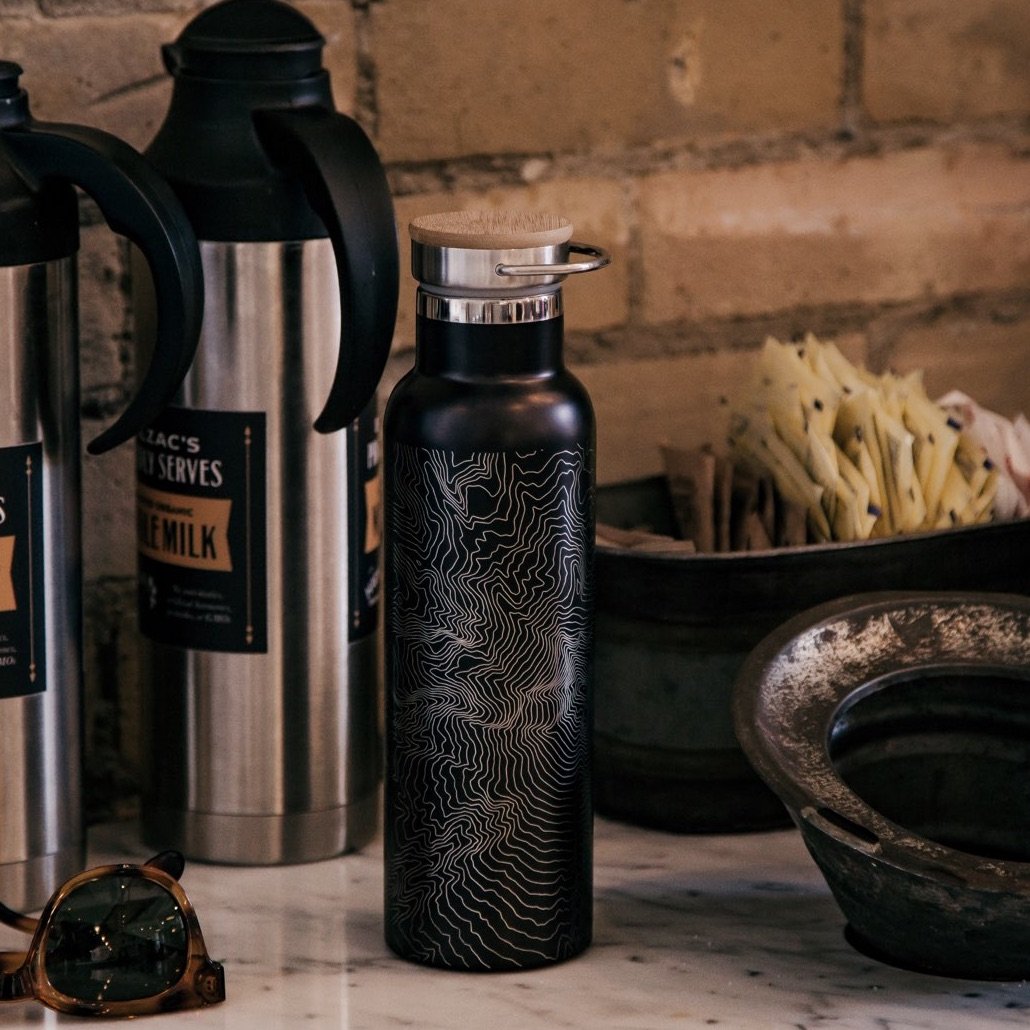 Custom engraved stainless steel bottle featuring a map of Zion National Park with a bamboo top in matte black finish.