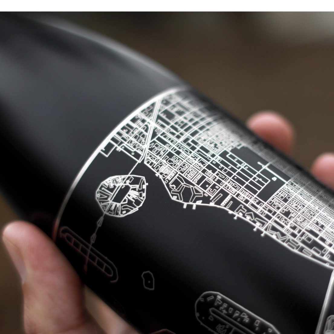 Matte black insulated bottle featuring a custom engraved map of Zion National Park, Utah, with coordinates.