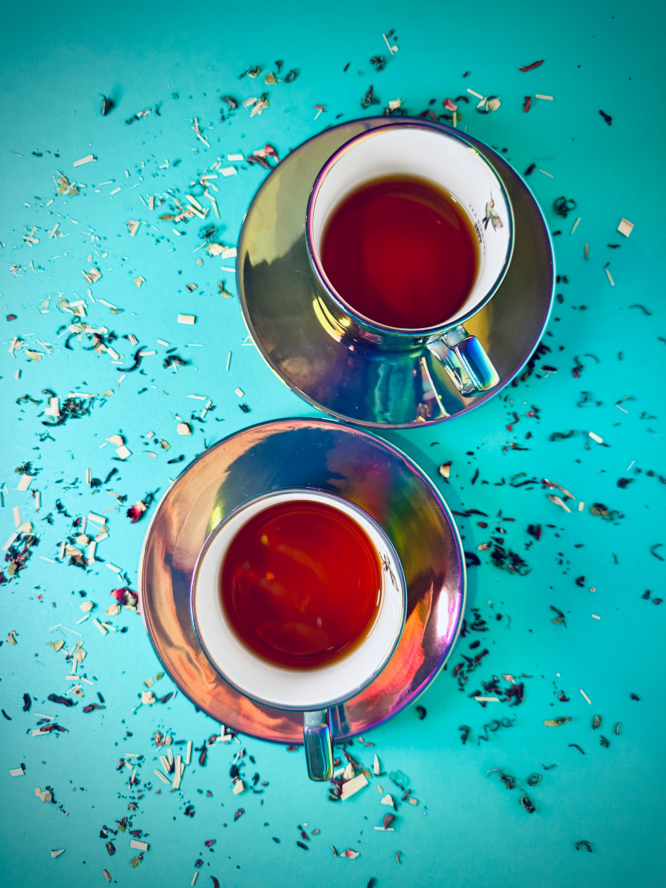 A stunning set of two rainbow chrome tea cups and saucers made from fine bone china, elegantly displayed in a gift box.