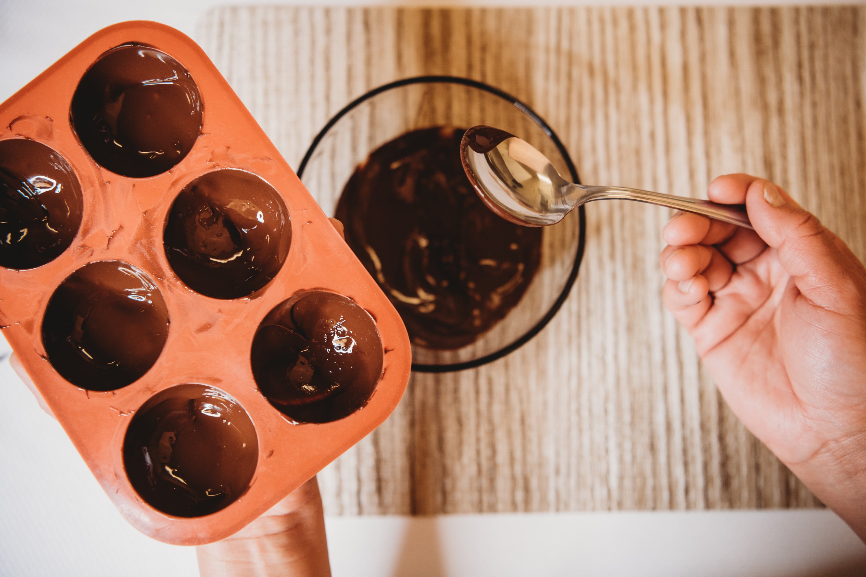 A 6 cavity silicone cocoa bomb mold with chocolate bombs, showcasing its design and functionality for making hot chocolate bombs.