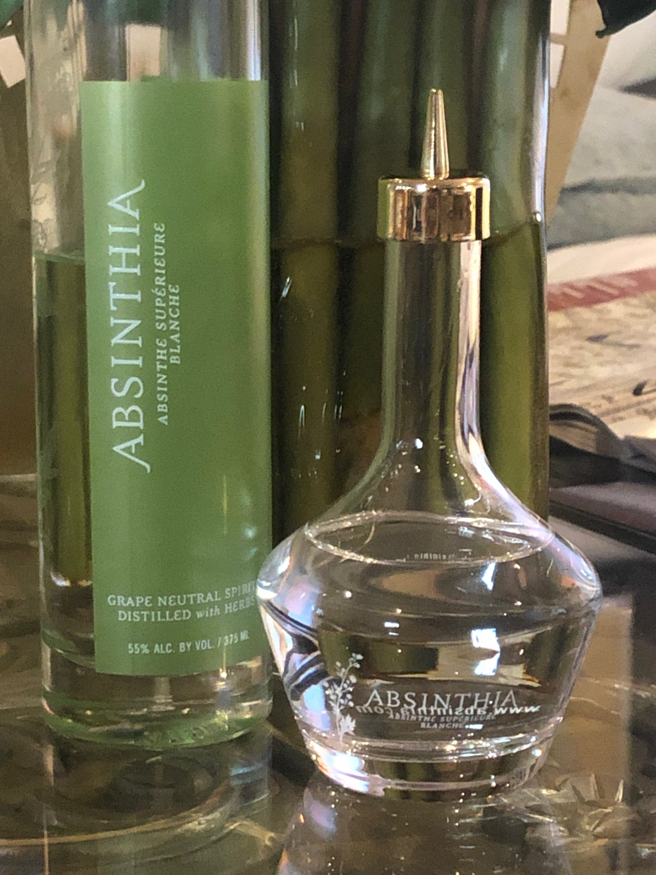 Elegant glass Absinthe Dasher Bottle with gold top, designed for precise pouring.